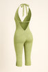 Green jumpsuit with a halter neck design on a beige background