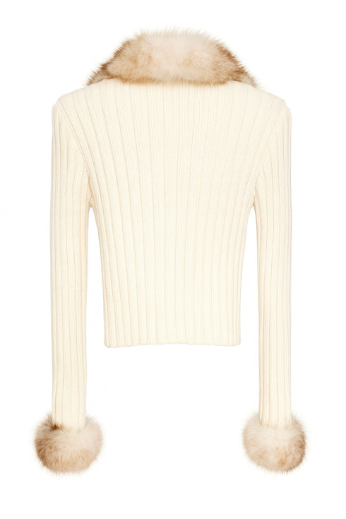 Cream-colored knitted cardigan with fur trim on a white background