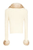 Cream-colored knitted cardigan with fur trim on a white background