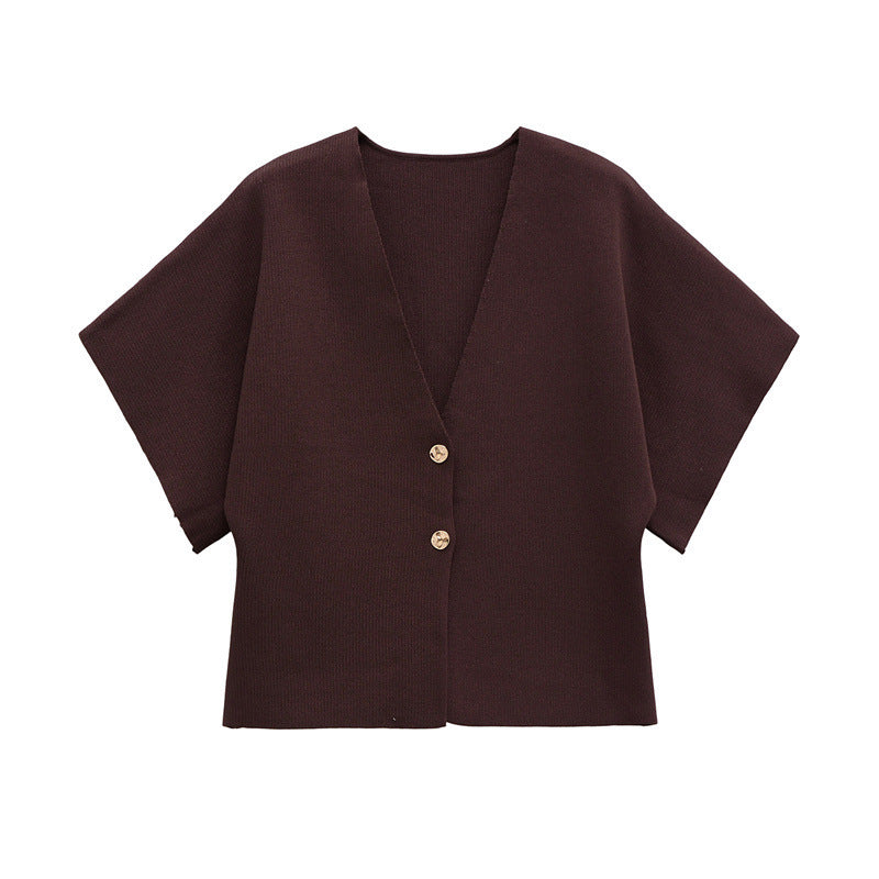 Brown cape-style garment with button details on a white background