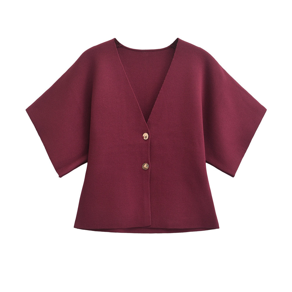 Maroon blouse with gold buttons on a white background