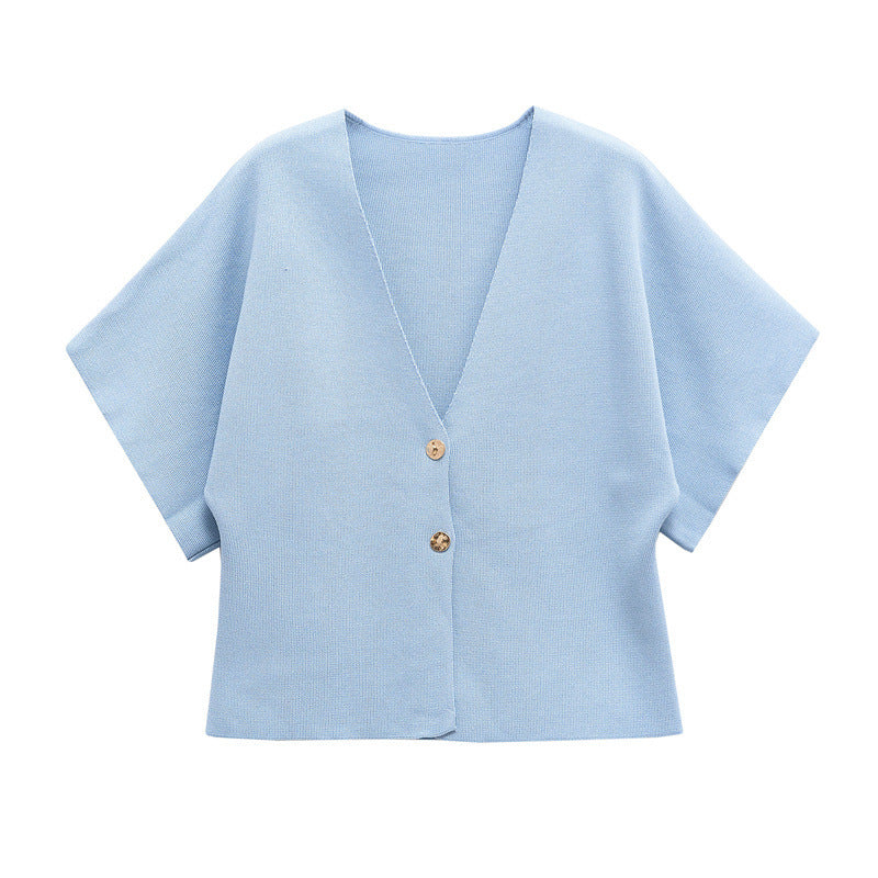 Light blue cardigan with button details on a white background