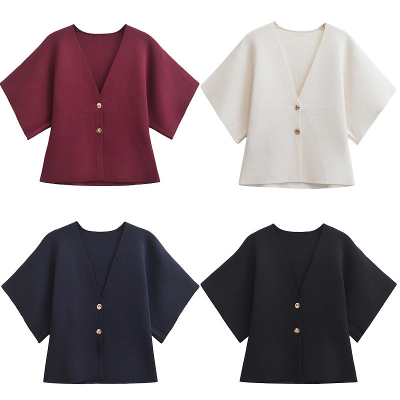 Four different colored tops with short sleeves on a white background